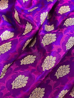 Gorgeous Banarasi Tanchoi Silk Saree. Handpicked from weavers of Banaras. Its a beautiful Half and half saree with Tanchoi and Buttis work on the half of the saree and the other half is just the tanchoi work. Item : Saree Color : Purple with Red with Muted Gold Zari Weave  Base Fabric : Banarasi Tanchoi Silk Blouse piece : Yes Blouse material : Banarasi Silk Work : Handwoven, handloom, zari woven, Handmade Fall & Edging(Pico) Yes/No : Yes Disclaimer -: - Color variation is possible due to variou Festive Brocade Saree With Self Design, Anarkali Brocade Blouse With Motifs, Festive Brocade Blouse Piece With Zari Weaving, Brocade Blouse Piece With Traditional Drape, Unstitched Brocade Traditional Wear With Self Design, Self Design Brocade Traditional Wear For Diwali, Anarkali Blouse Piece With Zari Weaving In Brocade, Brocade Traditional Wear With Zari Weaving For Puja, Unstitched Zari Weaving Choli For Celebration