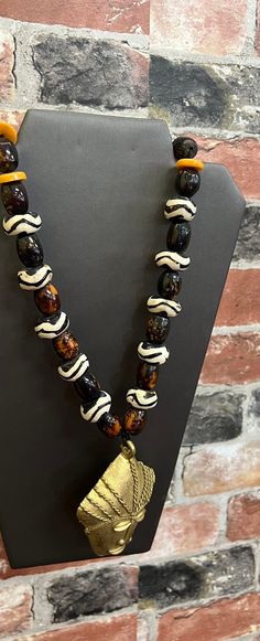 A breathe taking African necklace. The rich bone bead necklace make a strong Cultrual statement. The necklace is l7 inches in length.  No garment is complete with a statement piece. Don't delay order yours today. Black African Necklace, Adjustable Necklace With Large Beads For Rituals, Artisan Necklaces With Large Beads For Healing, Artisan Necklace With Large Beads For Rituals, Spiritual Large Beads Necklace For Rituals, Spiritual Necklaces With Large Beads For Rituals, Artisan Necklace With Wooden Beads For Rituals, Artisan Necklaces With Wooden Beads For Rituals, Artisan Necklace With Wooden Beads For Meditation