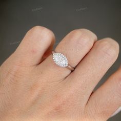 a woman's hand with a diamond ring on it