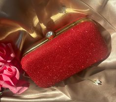 Add a touch of glamour to your outfit with this stunning Sparkle Red clutch! Made from high-quality materials, this clutch is designed to make a statement with its bold, eye-catching color. It will pair up with your any outfit. Huge space for phone and other makeup stuff. Carry it as clutch or Sling/Shoulder Bag. This clutch is non scratchy and glitter won't fall off. Product Details: Color : Red Material : Fabric Dimension : 7 (Length) * 4 (Hight) Sling Chain Length : 23 inch Weight : 0.66 lb. Closure : Clasp Closure Included : Removable Chain  Explore our other clutches range https://goddessgiggle.etsy.com handmade clutch wedding accessories ethnic clutch unique gift artisan made clutch Punjabi clutches bridal clutch crystal embellished clutch desi clutch luxury clutch Traditional clutch Red Clutch Purse, Wedding Clutch Bag, Clutch Bag Wedding, Luxury Clutch, Embellished Clutch, Red Clutch, Love Box, Handmade Clutch, Wedding Clutch