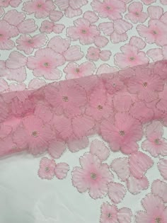 pink flowers on white fabric with gold sequins