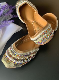 Traditional shoe/jutti Honeycomb . Made in Punjab, india. Entire shoe is made of genuine leather. For total comfort double cushion added. Leather lining to the side. Front and back has jari and head work. Completely hand made. Traditional Meenakari Slip-on Flats, Traditional Flats With Mirror Work For Navratri, Festive Handwork Leather Flats, Festive Leather Flats With Handwork, Traditional Dori Work Flats With Round Toe, Traditional Zari Work Flats With Round Toe, Traditional Flats With Zari Work And Round Toe, Traditional Flats With Dori Work And Round Toe, Navratri Closed Toe Flats With Mirror Work