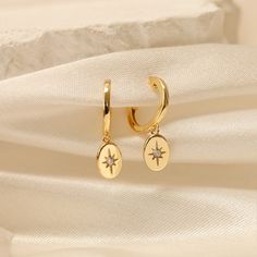 GOLD STARBURST HUGGIE HOOPS  These stunning handcrafted half-moon earrings feature a minimalist concept that is perfect for you or as a gift for her on any occasion. The timeless and elegant design is a beautiful accent to any outfit. Our best-selling gold earrings stack is designed with a focus on minimalist aesthetics and timeless charm. This everyday silver earring set combines the elegance of a solid silver material with the brilliance of a crescent moon charm, making it a must-have in your Elegant Gold Hoop Earrings With Star Charm, Gold Star-shaped Hoop Earrings With Ear Wire, Gold Star-shaped Jewelry With Dangling Charms, Gold Star Charm Hoop Earrings, Gold Hoop Earrings With Star Charm For Gift, Gold Hoop Earrings With Star Charm As A Gift, Gold Star-shaped Single Hoop Earring, Celestial Gold Dangle Hoop Earrings, Gold Star-shaped Hoop Earrings