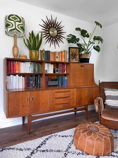 a living room filled with lots of furniture and plants on top of it's shelves