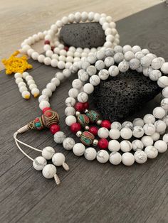 Beautiful Howlite Mala from Nepal and Mountain shell beads Mala necklace. You can choose between the mala that is made with howlite beads (white with gray) and mix metal beads from Nepal, or the all white mala necklace, which is made with mountain shell beads and a yellow mantra symbol. A unique praying mala that can be used as a necklace or as an ornament. The mala has no clasp, you wear it over the head. --The Mala with the metal beads and the red beads has a total length of 48.2cm- 19 inch lo White 108 Beads Mala For Meditation, White 108 Beads Jewelry As A Gift, White Beaded Bracelets With 108 Beads For Meditation, Adjustable White Spiritual Beads, White Mala With 108 Beads For Healing, White Healing Mala With 108 Beads, White Spiritual Beads, White 8mm Beads Mala For Meditation, White Adjustable Mala With Gemstone Beads