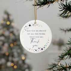 a white ornament hanging from a christmas tree with the words, may you be proud of all the work that you do