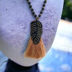 Stunning and unique hand beaded vintage artisan black and gold tassel necklace. The beaded necklace measures 32" all the way around (hangs down 16").   The beadwork and gold silky tassel measures 4" Unsigned, unknown artist.  Wonderful condition. Unique vintage handmade necklace. Thanks for looking! Black Artisan Necklaces For Beach, Black Artisan Necklace For Beach, Artisan Black Necklace For Beach, Bohemian Long Necklace With Black Round Beads, Adjustable Beaded Tassel Dangle Necklace, Adjustable Beaded Tassel Necklace With Dangle, Adjustable Beaded Dangle Tassel Necklace, Artisan Adjustable Beaded Fringe Necklace, Artisan Beaded Fringe Adjustable Necklace