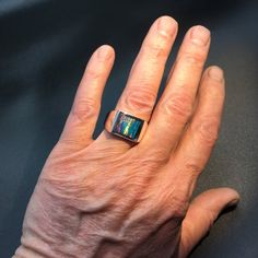 This is our own spin on a timeless classic. We've channel inlaid kyocera opal into our extra heavy mounting (approx. 19 grams). We softened the square just slightly and domed it a bit which gives it a classy look and feel.I like to think of my pieces as heirloom quality, built to last a lifetime.Stone:Lab-Created Kyocera Opal.I also make this ring on other stones:Black Onyx http://www.etsy.com/listing/61398623/mens-heavy-custom-square-black-onyx-ring Lapis http://www.etsy.com/listing/61398979/me Modern Formal Cabochon Opal Ring, Formal Modern Opal Cabochon Ring, Modern Formal Opal Ring With Cabochon, Modern Formal Opal Jewelry, Modern Gold Opal Ring With Polished Finish, Modern Collectible Rectangular Jewelry, Modern Opal Ring For Anniversary, Modern Opal Jewelry For Anniversary, Blue Star Sapphire