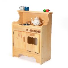 a wooden toy stove with two pots and pans on it's top shelf