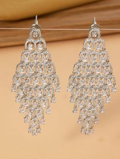 These diamond danglers with CZs offer a stunning blend of classic elegance and modern sparkle. The intricate design features dazzling diamonds complemented by radiant CZs, creating a harmonious play of light and brilliance. White Cubic Zirconia Diamond Earrings With Elegant Design, Fine Jewelry Diamond White Cubic Zirconia Chandelier Earrings, Diamond White Cubic Zirconia Chandelier Earrings, Diamond White Round Chandelier Earrings, Diamond White Cubic Zirconia Chandelier Earrings With Sparkling Stones, Fine Jewelry Chandelier Earrings In Diamond White, Glamorous Diamond White Chandelier Earrings With Sparkling Stones, Diamond White Chandelier Earrings, Glamorous Sparkling Diamond White Chandelier Earrings