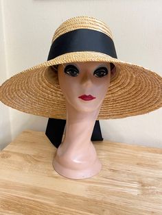 This 5.5 inch bell brim natural wheat straw is made from high-quality Milan braided sewn straw. The sloped brim is 5.5 inches and the crown is 4.5 inches deep. The band is 2 1/2 inch black grosgrain ribbon. The inside band has a sizing cord to adjust the head size. The hat is available in small/medium - Xlg head sizes. The hat has a sizing band inside to perfectly fit your head. The small/medium fits 22 - 22 3/4 inch head size. The large will fit 59cm 22 3/4- 23 1/4-inch head size and the extra-large hat is 61cm and will fit 23 - 24  inch head size, 7 1/2 fitted head size. Woven Straw Hat With Curved Brim, Natural Straw Visor Hat, Woven Straw Hat With Curved Brim For Kentucky Derby, Vintage Straw Hat Bands For Beach, Adjustable Toquilla Straw Hat For Garden Party, Wide Brim Woven Straw Hat, Adjustable Toquilla Straw Sun Hat For Garden Party, Handwoven Wide Brim Straw Hat, Natural Straw Boater Hat With Visor