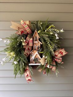 a christmas wreath hanging on the side of a house