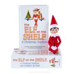 the elf on the shelf is sitting in front of an open box with candy bars