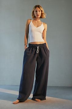 Out From Under sweatpant made special with piping details. Designed in a relaxed wide-leg silhouette featuring a ruffled elastic waistband with drawstring tie, side pockets and split hems. Exclusively at Urban Outfitters. Features Out From Under Hoxton piping wide leg sweatpant Wide leg sweatpant Soft and stretchy knit Ruffled elastic waistline with drawstring tie Side pockets with contrast piping down the sides Split hems Relaxed wide-leg fit Full length Easy pull-on style UO exclusive Content + Care 69% Cotton, 31% polyester Machine wash Imported Size + Fit Model in Ivory is 5’8" and wearing size Small Measurements taken from size small Inseam: 30" | Out From Under Hoxton Piping Sweatpant in Navy, Women's at Urban Outfitters Wide Leg Sweatpants Outfit, Urban Outfitters Sweatpants, Sweatpants Aesthetic, Wide Leg Sweatpants, Contrast Piping, Sweat Pants, Split Hem, Womens Bottoms, Fashion Forward