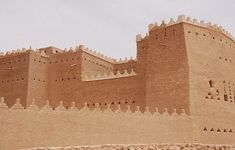 a large building made out of sand on the beach