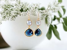 "These stunning Sapphire Earrings are the perfect addition to any jewelry collection. Handmade with care Classy blue color Dangle style with gold accents. Suitable for any occasion, including weddings and bridesmaid gifts. Their classic design is sure to make a statement and elevate any outfit. They are carefully crafted with attention to detail, making them a unique and special addition to your jewelry collection. The beautiful blue color of these earrings is truly captivating. The gold accents add an extra touch of elegance, making these earrings perfect for special occasions or everyday wear. If you're looking for a one-of-a-kind gift, then look no further. Whether you're shopping for yourself or someone special in your life, these Sapphire Earrings are sure to impress! Color = Light Sa Elegant Blue Crystal Earrings For Gift, Blue Drop Earrings For Bridal Gift, Blue Bridal Drop Earrings As A Gift, Blue Teardrop Bridal Earrings For Anniversary, Blue Drop Earrings For Anniversary, Blue Birthstone Earrings For Wedding, Blue Dangle Bridal Earrings Gift, Blue Dangle Earrings For Bridesmaids, Blue Drop Earrings For Bridesmaid Gift