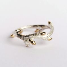 "From our BACK TO NATURE Collection... 14K gold budded twig ring produced by using traditional goldsmithing techniques. Buds are made from 14k solid gold and soldered to the sterling silver twig band one by one. Pattern on twig is also made by hand which makes each ring unique. **Details** ✪ Material: Buds: 14k Solid Gold Twig Band: Sterling Silver **Please be aware that the twig may get tarnished over time as it is a natural reaction for sterling silver. You may clean it with a plain, solid-colored toothpaste (not gel) with no baking soda, tartar control, or whitening agents. Just apply a small amount of toothpaste to the twig, brush with a toothbrush and rinse.  Please carefully select your ring size from the drop-down menu. We use standard US ring sizing but can find out your size in an Raw Rings, Branch Rings, Twig Jewelry, Deer Antler Ring, Measuring Scale, Romantic Nature, Wax Ring, Twig Ring, Branch Ring