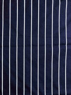 a blue and white striped fabric with vertical lines on the front, diagonally drawn