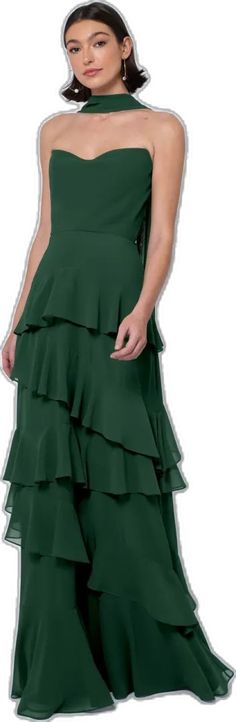 a woman wearing a green dress with tiered layers