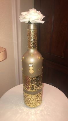 a gold vase with white flowers in it