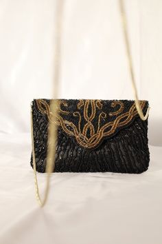 Glamorous & sophisticated black and gold beaded evening bag. The bag has a background of black taffeta. Front has large design of gold and black beading, with scallop flap and snap button closure. The back has black beads.  The bag interior is black with one pocket, spacious enough to hold an iPhone and lipstick. The beaded clutch bag also includes a gold cord chain strap to wear on your shoulder. Perfect for a glamorous special occasion or after five bag.   Vintage from 80's Height 5" Length 7. Luxury Black Beaded Evening Bag, Elegant Black Beaded Bags, Elegant Rectangular Shoulder Bag With Black Beads, Elegant Gold Bags With Sequins, Elegant Gold Sequined Bags, Elegant Sequin Shoulder Bag For Night Out, Evening Rectangular Bags With Black Beads, Evening Rectangular Shoulder Bag With Black Beads, Evening Shoulder Bag With Black Beads Rectangular Shape