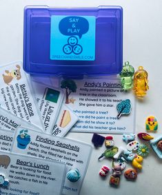 an assortment of buttons and magnets in a blue box with instructions on it sitting on top of a table