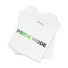 two white t - shirts with the words pride mode printed on them in green and black