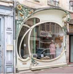 an old fashion store front window with a mannequin in it's reflection