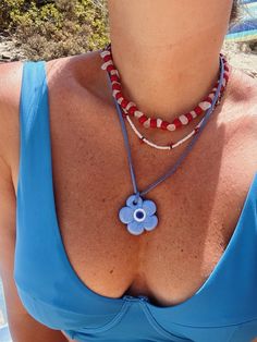 Our stunning chillax blue flower evil eye necklace is a beautiful and unique piece that perfectly combines elegance and charm.     featuring a hand-painted glass it showcases symbols of "luck" "protection" and "joy" embodying inner wisdom and positive manifestation.   it's not just an accessory; it's a conscious choice to align with your desired energies.     wear it solo or layered; the flower evil eye bead whispers tales of resilience and hope guiding you toward your own inner light.    the pendant hangs from a soft 100 cm long vegan suede string offering both comfort and style.    this versatile piece can be worn around your neck waist or even as a chic accent on a bag.    suede cord approx. 100 cm (39.37" )  glass evil eye flower pendant size: 4 cm (1.57" )    care    avoid contact wit Positive Manifestation, Eye Flower, Glass Evil Eye, Inner Wisdom, Full Cup Bra, Swimming Bag, Inner Light, Suede Cord, Jewelry Design Necklace