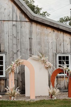 an outdoor wedding venue with large wooden letters and flowers on the side of the building