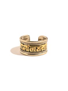 This adjustable ring is hand crafted by local artists of Nepal. It features the well known and oft chanted Tibetan holy mantra Om Mani Padme Hum artfully carved around the band, and a delicate rope like design decorating both sides. The brass ring can be gently pressed together to adjust to whichever finger on which you choose to wear it. Attractive and adjustable. Band measures almost 1/2 inch wide. Handcrafted in Nepal. Om Mane Padme Hum, Om Mani Padme Hum, Brass Ring, Local Artists, Adjustable Ring, Adjustable Rings, Mantra, Nepal, The Well