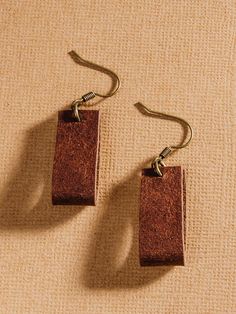 These handmade leather earrings add understated elegance to your outfit in a wearable loop design. Leather Strap Jewelry For Everyday Use, Everyday Jewelry With Leather Strap, Elegant Leather Jewelry For Everyday, Everyday Leather Jewelry In Rectangular Shape, Handmade Earrings For Everyday Use, Everyday Rectangular Leather Jewelry, Trendy Brown Jewelry With Leather Strap, Trendy Brown Leather Jewelry, Elegant Brown Hoop Earrings For Everyday