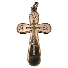 This antique Russian 14K rose gold cross pendant with hand-engraved decorations was made in St. Petersburg between 1899 and 1903. The abbreviation ‘IC’ – ‘XC’ on the horizontal arms of the cross stands for Jesus Christ. The cross is marked with 56 zolotnik old Russian gold standard with initials ‘ЯЛ’ for St. Petersburg assay master Yakov Liapunov (1899-1903) and maker’s initials ‘PB’ for Rudolf Weide, a prominent jeweler of the period. The cross measures (without suspension ring) 39 x 22 mm (1 1 Antique Yellow Gold Crucifix Jewelry, Antique Yellow Gold Cross Pendant Jewelry, Antique Hallmarked Crucifix Jewelry, Antique Hallmarked Cross Pendant Jewelry, Vintage Hallmarked Cross Necklace, Bronze Engraved Cross Pendant Jewelry, Antique Pendant Cross Necklace As Gift, Crucifix Shaped Engraved Jewelry For Commemoration, Vintage Cross Necklace With Hallmark