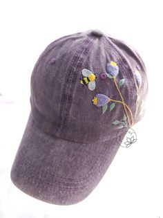 Hand Embroidered Floral And Bee Denim Baseball Cap Material: This denim cap is embroidered by cotton thread. You can adjust circumference of the hat. - Cap circumference : 54-60 cm - Cap depth: 12 cm - Cap brim length: 7 cm -Color: Purple I love embroidery and I think this is a gift of thought for this life. If you like, own it or give this meaningful gift to relatives and friends. NOTE: The color can slightly be different due to monitor setting. Please make sure you do not mind this when purchase. **Have a look at my other products here: https://www.etsy.com/shop/AnhsEmFash **My Instagram : https://www.instagram.com/anhsemfash Thank you so much for shopping with me! _Anh's EmFash_ Purple Cotton Baseball Cap, Purple Cotton Baseball Cap With Curved Brim, Adjustable Cotton Hat With Embroidered Patch, Spring Cotton Trucker Hat With Curved Brim, Cotton Brimmed Trucker Hat In One Size, One Size Cotton Brimmed Trucker Hat, Spring Cotton Snapback Trucker Hat, Cotton Snapback Trucker Hat For Spring, Spring Hats With Embroidered Patch, One Size Fits Most