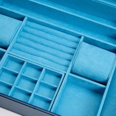 an open blue box with several compartments in it