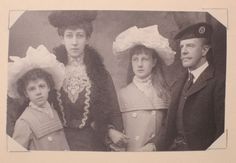 an old black and white photo of three people with hats on their heads, standing next to each other