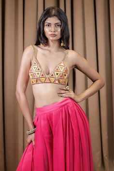 Pink bralette featuring mirror and thread embroidery in a geometric pattern. Paired with an attached cancan sharara for a complete look., Fit: Relaxed Pink Sharara With Mirror Work For Summer, Festive Sets With Geometric Embroidery For Diwali, Festive Diwali Set With Geometric Embroidery, Pink Sleeveless Sets With Mirror Work, Pink Summer Sets With Mirror Work, Summer Reception Pink Choli, Glamorous Pink Summer Sets, Pink Lehenga With Unstitched Blouse For Summer, Pink Fitted Sharara For Summer