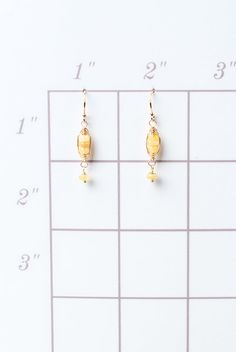 A beautiful gift for those born in October, featuring their birthstone of stunning opal that is hand wrapped in a gold filled herringbone weave. These feminine earrings dangle from gold filled earwires. Gold Filled (lead and nickel free) Opal 1.25", on gold filled earwires We hand select our natural materials, thus there may be slight variations in color and/or size that will not detract from the overall aesthetic Our unique handcrafted designer jewelry for women is made in America, with each de Gold Wire Wrapped Linear Earrings As Gift, Wire Wrapped 14k Gold Filled Yellow Gold Earrings, Gold Wire Wrapped Linear Earrings For Gift, Gold Wire Wrapped Earrings With Czech Glass, 14k Gold Filled Wire Wrapped Yellow Gold Earrings, Hypoallergenic Gold Opal Jewelry, 14k Gold Filled Birthstone Dangle Earrings, Gold Hypoallergenic Opal Jewelry, Yellow Gold 14k Wire Wrapped Earrings