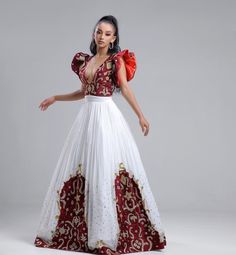 This stunning Habesha Kemis is a true masterpiece of Ethiopian fashion. The luxurious Menen fabric drapes elegantly over the body, creating a flattering silhouette. The upper portion of the dress features a Shimena top, which is a traditional Ethiopian blouse with a loose, flowing fit. The Shimena top adds a touch of elegance and sophistication to the dress. The lower portion of the dress features a Tilf design at the bottom, which is a traditional Ethiopian pattern that is often used in Habesha Ethiopian Pattern, Ethiopian Fashion, Eritrean Dress, Habesha Dress, Ethiopian Dress, Habesha Kemis, Cultural Festival, Draped Fabric, Ethiopia