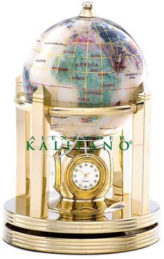 a golden clock with a globe on top