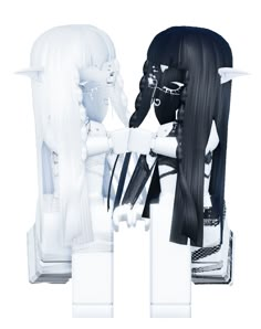 two white and black dolls sitting next to each other