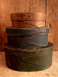 a stack of old leather belts sitting on top of a wooden table