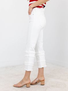 A more trend forward take on denim for the summer season! These unique and updated denim jeans feature a cropped length and flared leg opening, adding an extra touch of style to your look. The frayed tiered design and crisp white wash give them a trendy edge that will make you stand out in any crowd. Elevate your wardrobe today! A fun way to update a classic look. Liverpool Cropped length Frayed tiered accents Crisp white coloration 69% Cotton, 24% Modal, 6% Polyester, 1% Elastane Rise: 8.5" Ins Spring High Rise Stretch Cropped Jeans, Spring Stretch Flare Jeans With Frayed Hem, White High Rise Flare Jeans With Frayed Hem, White High-rise Flare Jeans With Frayed Hem, Chic Denim Cropped Jeans With Frayed Hem, Chic Cropped Denim Jeans With Frayed Hem, Summer Flare Jeans With Frayed Hem, Summer Flare Pants With Frayed Hem, Spring Cropped Jeans With Frayed Hem