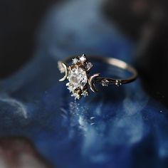 a diamond ring sitting on top of a blue surface