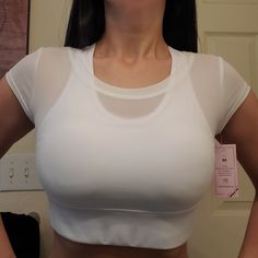 Never Worn Except To Take Photo. Padded Bra Attached To Sheer Shirt. Sizes Medium & Large Available. White Sporty Crop Top With Built-in Bra, Sporty Mesh Top For Athletic Wear, Fitted Mesh Top With Breathable Fabric, Casual Mesh Short Sleeve Crop Top, White Sportswear Crop Top For Summer, White Mesh Stretch Crop Top, White Breathable Medium Support Top, White Breathable Top With Medium Support, White Athleisure Top With Built-in Bra