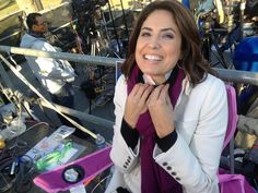 a woman sitting in a purple chair with her hands on her chest smiling at the camera