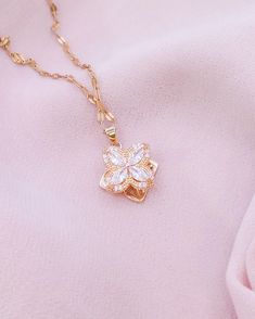 Embrace the grace of spring with our Blossoming Charm Necklace, featuring a delicate crystal flower pendant that sparkles with every turn. Suspended from a dainty gold chain, this necklace is a versatile piece that brings a touch of nature's beauty to your ensemble. It's perfect for layering or wearing solo as a subtle, yet enchanting statement. Need help? Want to purchase a bulk order? Get in touch! ~ Email: contact.aurumgrace@gmail.com ~ Instagram: @AurumGrace All images are copyrighted by Aur Feminine Flower Necklace With Clavicle Chain, Feminine Flower Pendant Necklace With Clavicle Chain, Feminine Flower Pendant Necklace, Feminine Necklace With Flower Pendant For Her, Feminine Necklace With Flower Charm, Feminine Necklace With Flower Pendant As Gift For Her, Feminine Flower Necklace With Clavicle Chain For Gift, Feminine Flower Pendant Necklace Gift For Her, Feminine Flower Pendant Necklace As Gift For Her