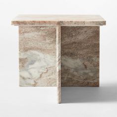 a marble side table with an open section on the top and bottom, in beige tones