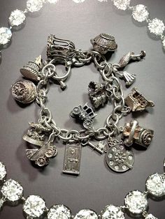 Thank you for viewing Wrenn Estate. Spectacular Wedding themed charm bracelet. 6 of them open! 4 have movable parts! Toggle clasp. Fantastic wedding gift! 7 1/2 inches Bird in a cage, opens Baby in a basket, opens Stork with baby, moves Wedding bells Home, opens I love you phone dial, moves Telephone Carriage, opens Door and key Baby in carriage, moves Carousel, moves Wedding cake, opens Wedding cake with enamel bride and groom, opens 66.42 grams sterling silver Affordable Silver Bracelet With Vintage Charm, Antique Silver Heirloom Jewelry, Heirloom Antique Silver Collectible Jewelry, Heirloom Style Vintage Charm Bracelet For Gift, Heirloom Charms Jewelry For Collectors, Heirloom Silver Jewelry Collectible, Elegant Antique Silver Jewelry With Charms, Heirloom Nickel-free Collectible Jewelry, Vintage Charms Jewelry For Wedding