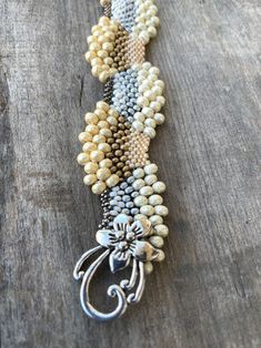 "I wanted to create some pieces that reflected how I feel about Snow, holidays and Winter. This is a custom, original design by Sonserae Designs. I love choosing the colors first...All the things that remind me of transitioning to Winter and the Holidays. All the beads are high quality Japanese Glass beads of various sizes. It's a great, unique gift for the holidays or any special occasion...hand beaded by me with love and care. I'm also able to make it in different colors if you prefer. I hope Handmade Beige Bracelets With Round Beads, Artisan Silver Beaded Bracelets With Unique Variations, Handmade Gold Beaded Bracelets As Gifts, Handmade Gold Beaded Bracelets For Gifts, Handmade Cream Pearl Bracelet Gift, Handmade Cream Bracelet Jewelry, Handmade Cream Beaded Bracelet As Gift, Handmade Cream Beaded Bracelet Gift, Handmade Cream Pearl Bracelet With Round Beads